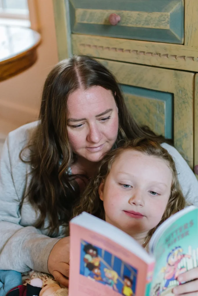 Abi Ayres reading to child.